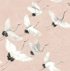 a flock of white birds flying across a pink sky