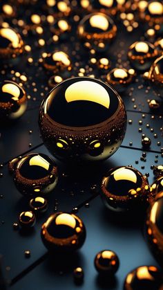 an array of shiny balls and bubbles on a black surface with yellow lights in the background