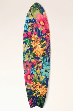 a colorful surfboard with flowers on it hanging from the wall in front of a white background