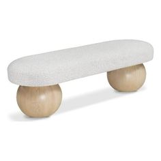 a white bench sitting on top of a wooden base