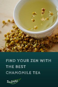 a bowl filled with green tea sitting on top of a wooden table