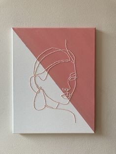 a pink and white square with a woman's face on it