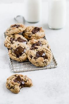 chocolate chip cookies on a cooling rack with milk