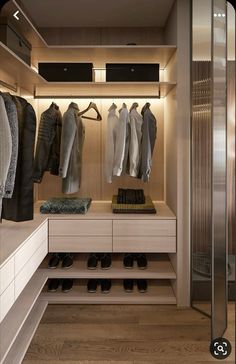 a walk in closet filled with lots of shoes and coats hanging on the wall next to each other