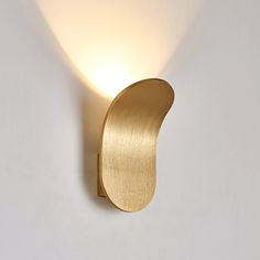 a light that is on the side of a wall with a white back ground behind it