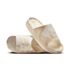 Enjoy a calm, comfortable experience—no matter where your day off takes you. Made with soft yet responsive foam, these marbled slides feature a minimal design that’s easy to wear. And they’ve got a textured footbed to help keep your feet in place. Whether you’re lounging on the couch, hanging in the city or vacationing on the coast, do it in effortless style. Contoured design is made from a single piece of foam for a smooth, seamless feel. Textured footbed provides grip to help keep your feet in Non-slip Foam Slip-on Slides, Comfortable Non-slip Outdoor Slides, Non-slip Foam Slides For Beach, Sporty Non-slip Foam Slides, Beige Non-slip Slides For The Beach, Minimal Design, Effortless Style