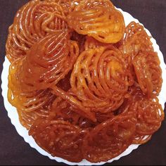 there are many different types of food on the white plate and one is brown in color