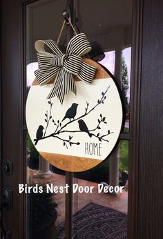 a door hanger with a bird on it and the words birds nest door decor