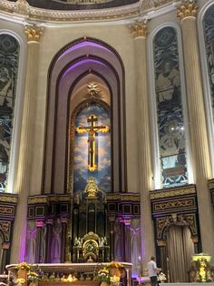 the interior of a church with an ornate alter and stained glass windows