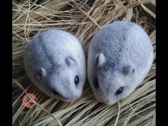 two small stuffed animals sitting on top of hay