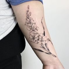 a black and white flower tattoo on the arm