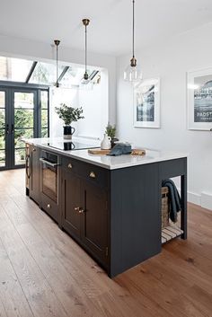 a kitchen with an island and wooden floors