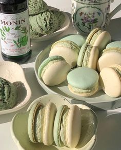 there are many different types of macaroons on the plates next to each other