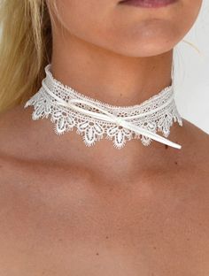 DETAILS: Wide lace choker necklace available in black and white Bow tie detail Bow tie can be adjusted Choker measures approx. 12" length, with a 2" extension 1 3/4" wide Gold plated lobster claw closure Elegant White Choker For Festivals, White Adjustable Choker Jewelry, Elegant White Summer Choker, Elegant White Choker For Summer, Adjustable White Choker For Festival, White Choker For Festivals, White Spring Party Choker, White Lace Choker Gift, Adjustable Choker For Wedding In Spring