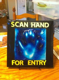 a sign on a table that says scan hand for entry