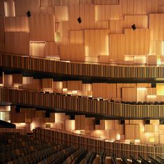 an auditorium filled with lots of wooden seats