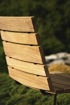 a wooden bench sitting on top of a lush green field