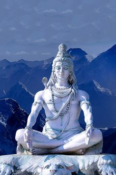 there is a white statue sitting on top of a mountain with mountains in the background