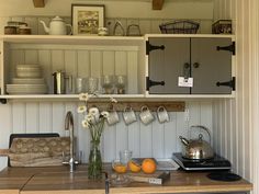 the kitchen counter is clean and ready to be used as a coffee bar or breakfast bar