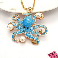 an octopus necklace with pearls on a plate