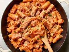 a skillet filled with pasta and sauce