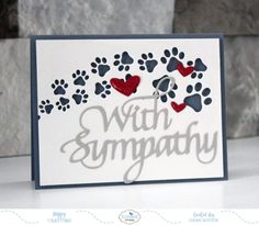 a card with paw sympathy written on it and two hearts in the middle, surrounded by dog paws