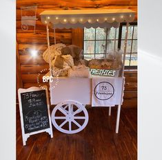 an old fashioned ice cream cart on display in a log cabin with wood flooring