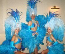 three women in blue costumes posing for the camera