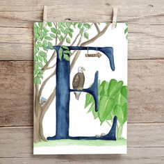 the letter e is painted with watercolors and has an eagle perched on it