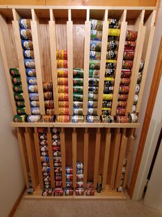 a wooden shelf filled with cans and cans