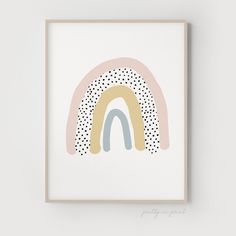 a framed print with a rainbow and polka dot design on the bottom half of it