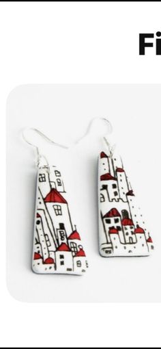 two white and red houses are hanging from earrings