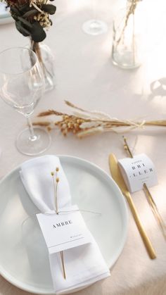 the place setting is ready to be served at this wedding reception, with goldware and napkins