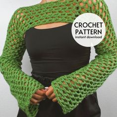 a woman wearing a green crochet sweater and black top with her hands on her hips