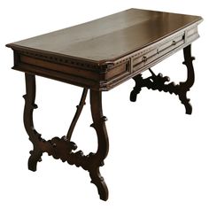 an old wooden desk with ornate carvings on the top and bottom edge, against a white background