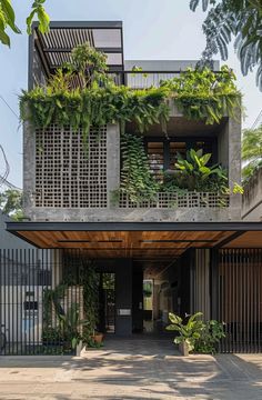 the entrance to an apartment building with plants growing on it's walls and balconies