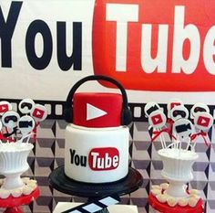 there is a cake and cupcakes on display at this youtube birthday party with red, white and black decorations