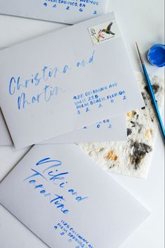 cool grey envelopes with blue watercolor brush lettering in script and print style writing Wedding Envelopes Calligraphy, Blue Envelope Wedding Invitation, Letter Addressing Creative, Wedding Address Envelopes Handwriting, Blue Watercolor Wedding Invitations, Handwritten Wedding Invitations Envelope, 2024 Wedding Invites, Envelope Seal Ideas, Envelope Addressing Creative