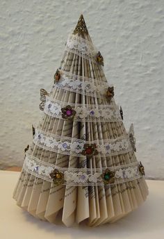 an origami christmas tree made out of old book pages with butterflies on it