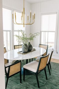 a dining room table with chairs around it