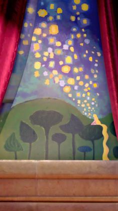 an artistic scene painted on the side of a stage with trees and stars in the sky