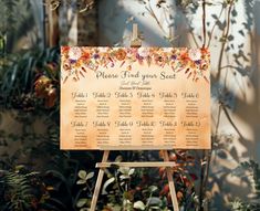 a sign with flowers on it in front of some plants