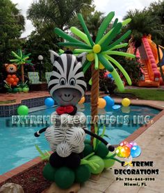 an inflatable zebra sitting on top of a tree next to a swimming pool