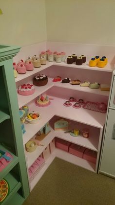 a room filled with lots of different types of cakes and cupcakes on shelves