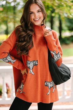 We think it's going to be a quick decision for you to put this cute sweater in your cart! It's obviously cute with that tiger print but it's also super cozy making it perfect for the fall! This mock neck sweater is going to look so cute with skinny jeans and boots or booties! Mock neckline Long fitted sleeves with drop shoulders Side slits Tiger print Generous stretch Sydney is wearing the small. Cute Knit Tops For Fall, Casual Winter Sweater With Cat Print, Casual Cat Print Sweater For Winter, Casual Fall Sweatshirt With Cat Print, Casual Long Sleeve Tiger Print Tops, Trendy Tiger Print Tops For Fall, Cute Cozy Fall Sweater, Cute Cozy Fit Sweater For Fall, Tiger Sweater