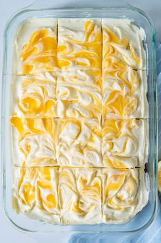 an image of a dessert in a glass baking dish with lemons on the side