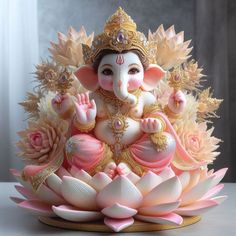 there is a statue of an elephant sitting on top of a lotus flower arrangement in pink and gold