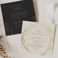 the wedding stationery is laid out on top of the table with gold foil and black paper