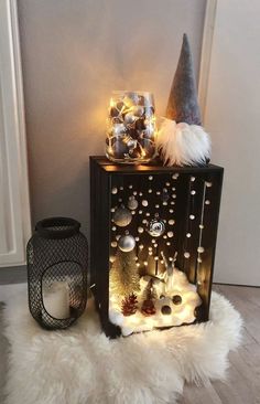 a small shelf with christmas decorations and lights on it, next to a candle holder