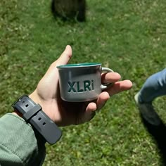 a person holding a coffee cup with the word xlr on it in their hand